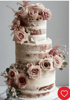 a wedding cake with pink flowers and greenery