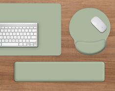 a computer keyboard and mouse sitting on top of a wooden desk