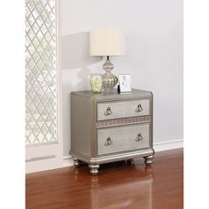 a silver nightstand with two drawers and a lamp