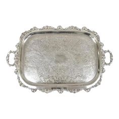 an ornate silver tray with handles