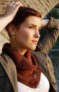 a woman wearing a brown scarf and jacket