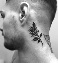 a man with a rose tattoo on his neck