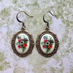 These Victorian garden inspired earrings feature beautiful vintage glass decal cameos with wonderfully detailed and richly coloured anemone flower bouquets. These delicate cameos are framed in to pretty antique brass Rococo style settings. These pretty anemone earrings hang from antique brass Silver Trumpet, Victorian Earrings, Romantic Earrings, Victorian Garden, Botanical Earrings, Cameo Earrings, Fairy Jewelry, Anemone Flower, Music Jewelry