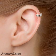 a woman's ear is shown with a tiny gold nose pin in the middle