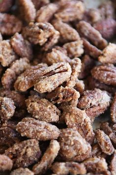 a pile of pecans sitting on top of a table next to another pile of nuts