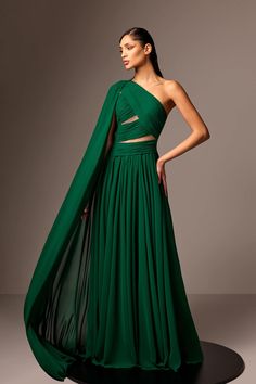 Description Dark Green A-line, Long dress Sleeveless Open neckline One Shoulder Crepe Modifications Accepted Custom Measurements Accepted Dry Clean Evening Dress Made in Lebanon 823 Georgette Gowns, Dark Green Gown, Edward Arsouni, One Shoulder Cape, Georgette Gown, Embroidered Tulle Dress, One Sleeve Dress, Shoulder Cape, Crepe Gown