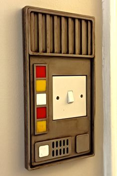 a star wars electronic device mounted to the side of a wall with buttons on it