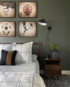 a bed room with a neatly made bed and three pictures on the wall above it