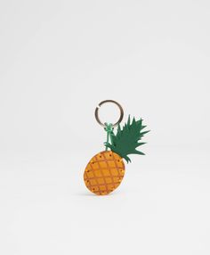 a pineapple shaped keychain on a white background