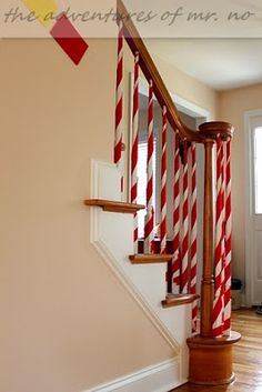 a staircase with red and white striped railing