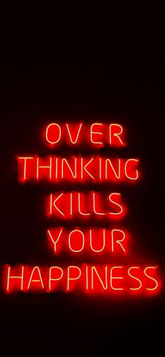 a neon sign that says over thinking kills your happiness