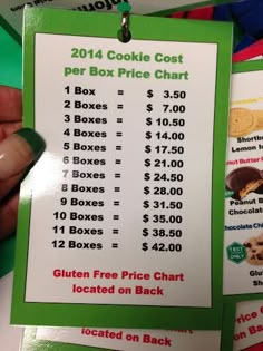 a person holding up a price card for cookies