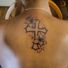 a man with a cross tattoo on his back