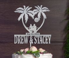 a wedding cake with the name drew and stagey on it, surrounded by greenery