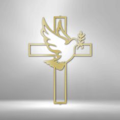 a golden cross with a dove on it