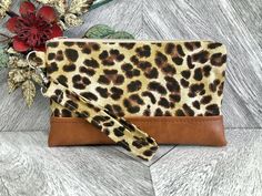 "An exterior zipper pocket can be added for an additional cost. Please message me prior to purchasing this listing. This cute wristlet wallet is the perfect go to alternative to our everyday handbags! It will hold all your necessities including credit cards, ID and your smartphone. Super convenient for the mom on the go!! This sleek and contemporary wristlet clutch was designed using a leopard print fabric. It has a faux tan leather base and a detachable strap. The well organized interior is a s Gift Wristlet Clutch With Wrist Strap, Gift Clutch Wristlet With Wrist Strap, Gift Wristlet With Wrist Strap, Brown Wristlet With Zipper Pouch For Gift, Brown Wristlet With Zipper Pouch As Gift, Brown Adjustable Pouch Wristlet, Adjustable Brown Pouch Wristlet, Everyday Handbags, Chapstick Lip Balm