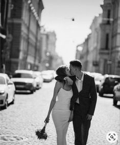 a man and woman kissing on the street