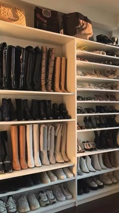 a closet filled with lots of shoes and bags