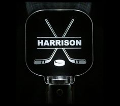 a lighted sign that says harrison with two hockey sticks