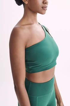 Elevate your everyday.The FLOYD One Shoulder Crop Top is a bold and chic addition to your activewear collection that seamlessly marries style with functionality. The asymmetrical neckline and one-shoulder design create a fashion-forward silhouette, while the cutout double strap detail adds a touch of avant-garde flair. With an elastic underbust for optimal support, this crop top is tailored for low-impact activities such as yoga and pilates, providing both comfort and style. Elevate your workout ensemble with Floyd, where innovative design meets the needs of the modern, dynamic woman. Complete the look with the Martina Bike Shorts With Pocket for your next yoga sesh. Suitable for low impact activities such as yoga, pilates and weight training. One Shoulder Stretch Top With Built-in Bra, Fitted One-shoulder Top With Built-in Bra, Chic Compressive Activewear For Workout, Fitted Green One Shoulder Top, One Shoulder Stretch Athleisure Activewear, One-shoulder Athleisure Activewear With Stretch, One Shoulder Athleisure Activewear For Sports, Chic High-stretch Activewear For Workout, Chic High Stretch Activewear For Gym