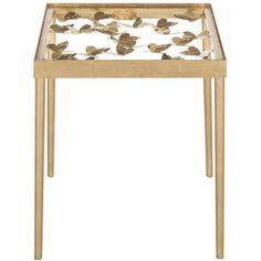 a gold metal and glass side table with leaves on it