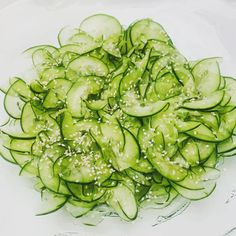 cucumber slices with sesame seeds on a glass plate