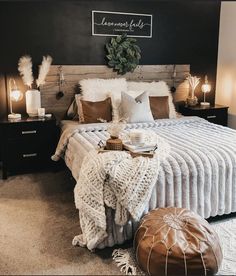 a bed with blankets, pillows and lights on top of it in a room that has carpeted flooring