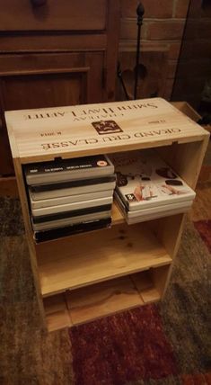 a wooden shelf with dvd's on top of it