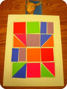 an animal head is on top of a piece of paper with colored squares in it