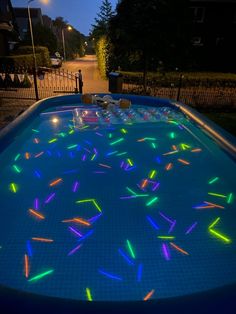 an inflatable swimming pool with colorful lights on it