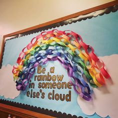 a rainbow painted on the side of a building with words below it that read be a rainbow in someone else's cloud