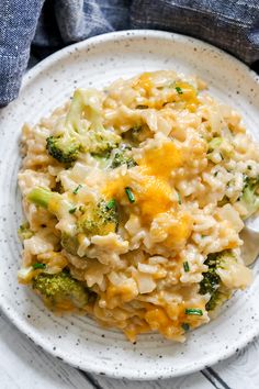 a white plate topped with rice and broccoli