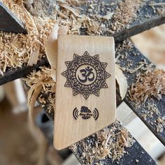 a wooden ornament sitting on top of a piece of wood