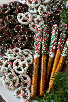 christmas cookies and pretzels are arranged on a platter