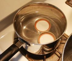 two pans sitting on top of a stove next to each other