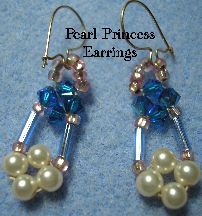 earrings with pearls and blue swarongs are shown on a blue cloth background