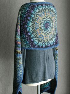 a sweater on a mannequin with a blue and yellow design in the middle