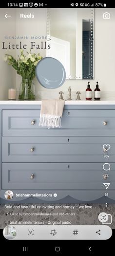 the bathroom is decorated in shades of blue and white, with an interesting mirror above it