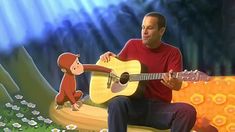 a man sitting on top of a bench holding a guitar next to a cartoon monkey