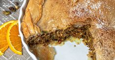 a close up of a pie on a plate with orange slices