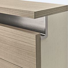 a close up view of a wooden cabinet with metal handles