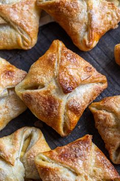 several pastries are arranged on a wooden surface