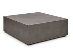 a square concrete table sitting on top of a white floor