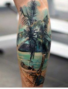 a man's leg with a palm tree and boat in the water on it