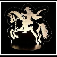 the silhouette of a horse and rider is shown on a black background with a white border