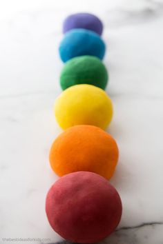 colorful play dough lined up in a row