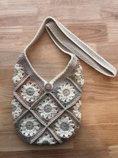 a crocheted purse sitting on top of a wooden floor