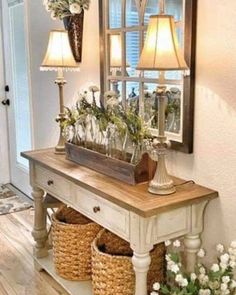 a table with baskets and flowers on it in front of a mirror that is reflecting the light