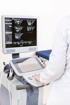 a person standing in front of a computer monitor with an x - ray on it