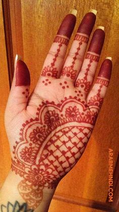 the hand is decorated with henna designs